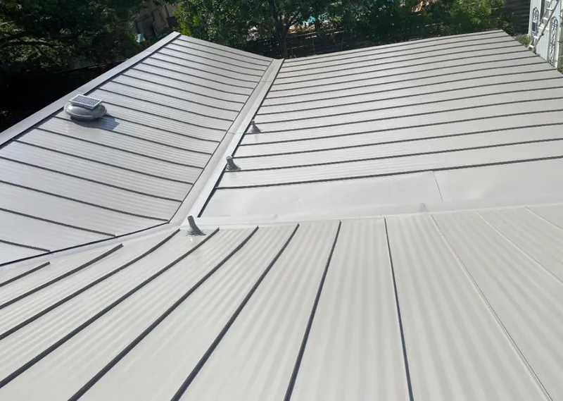 Solar attic fan installed on a metal roof for Roof Ventilation in Christiana